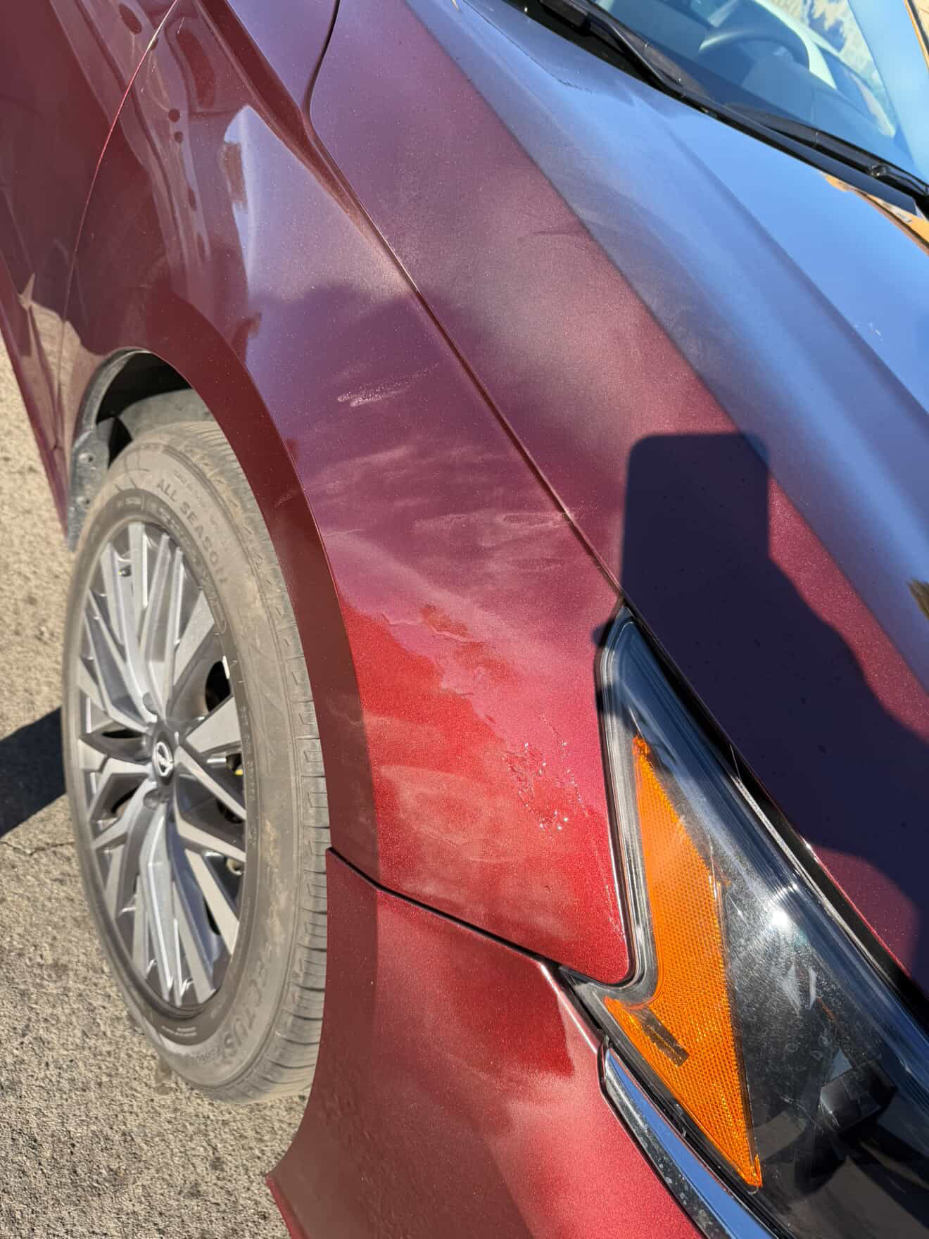 Nissan Altima fender scuff blended and refinished — before