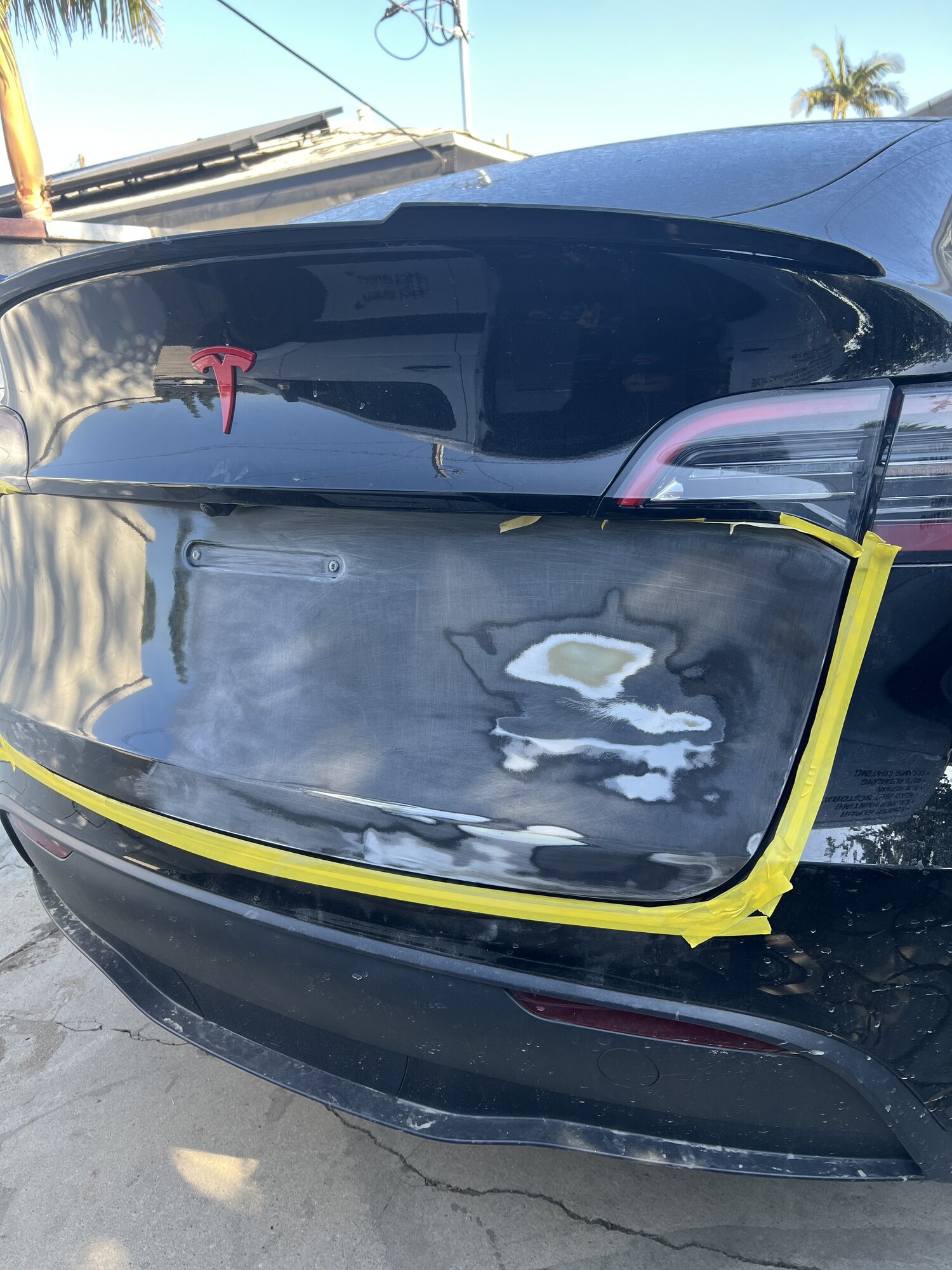 Tesla Model Y trunk dent pulled and refinished — after