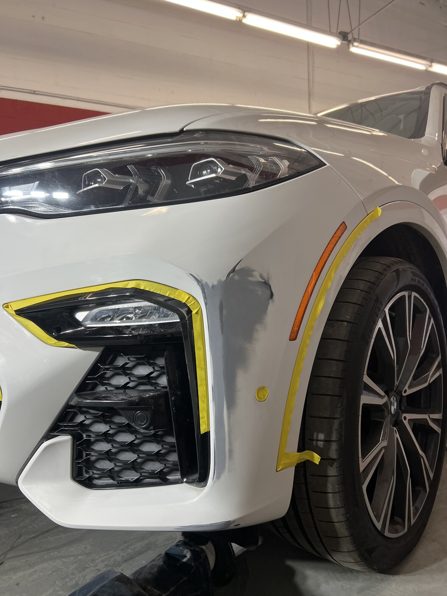 BMW X7 front bumper damage repaired and repainted — after