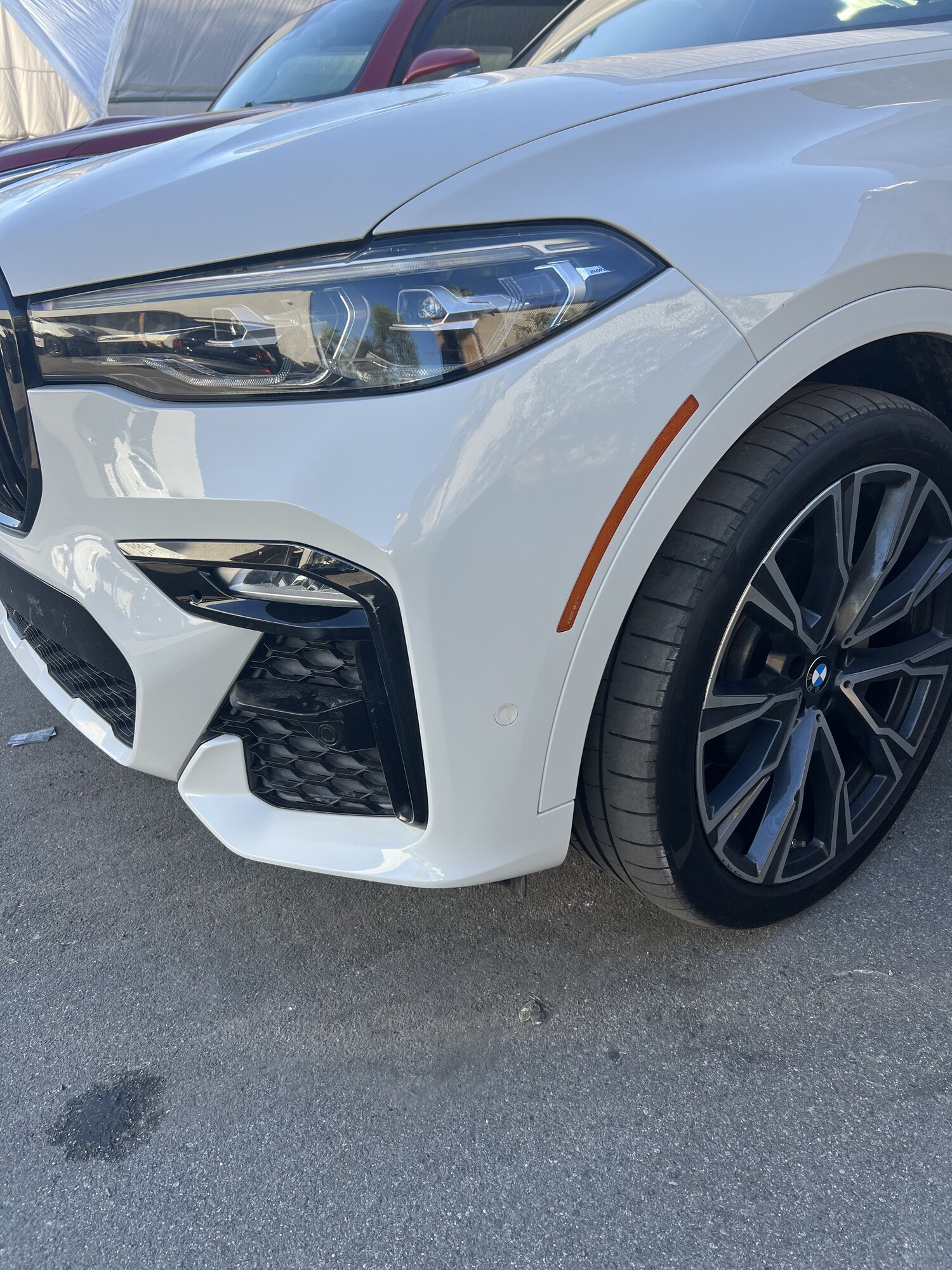 BMW X7 front bumper damage repaired and repainted — before